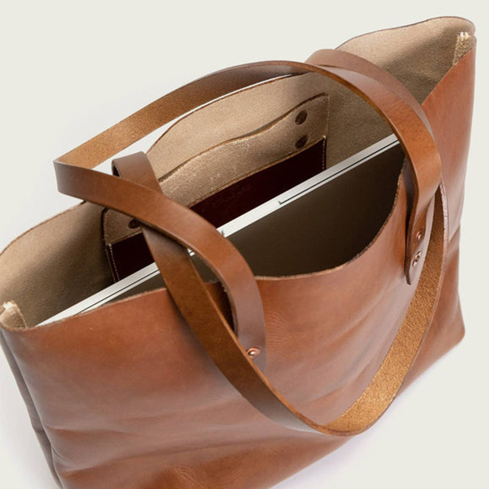 Unlined leather tote interior with drop pocket for storage